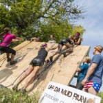 Participants of Uffda Mud Run Climbing a Wall Near The Grand Forks Greenway CVB Credit