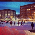 Teams Playing Broomball in Downtown Grand Forks Town Square Ice Rink in Winter