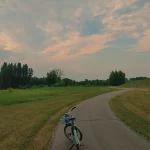 Bike in Grand Forks Greenway with sunset in background.