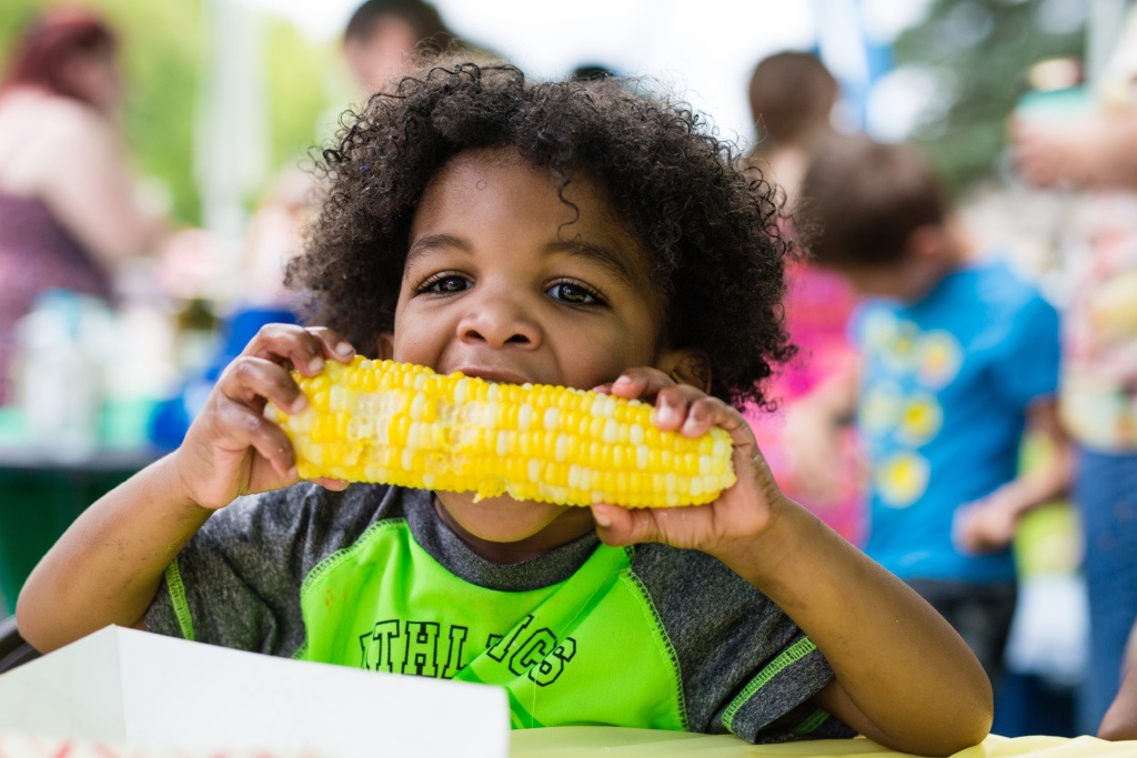 Boy Enjoying Corn at Emerado Corn Feed in Grand Forks County