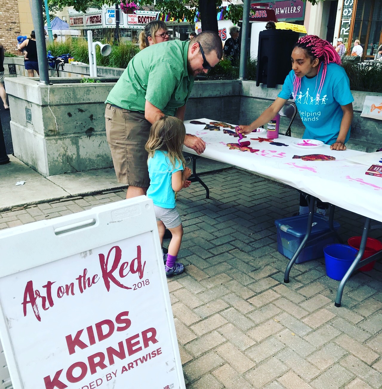 Child and Father Enjoying Art on the Red in Best City to Raise a Family Grand Forks