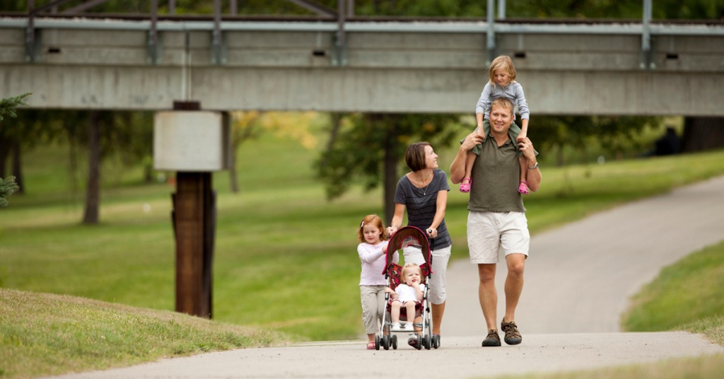 Family Walking on Grand Forks Greenway and Enjoying a Healthy Lifestyle in Grand Forks North Dakota