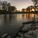 Men Fishing on the Red River Near the Grand Forks Greenway During Sunset