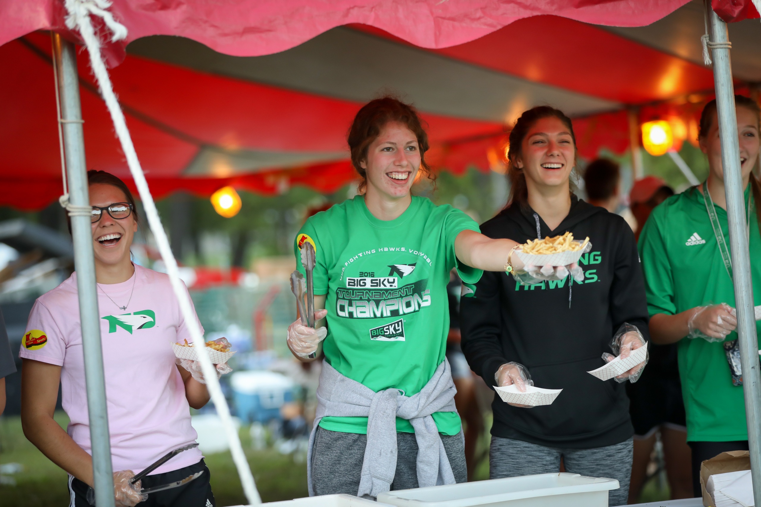 UND Female Athletes Serving French Fries at Grand Forks Potato Bowl Outdoor Event