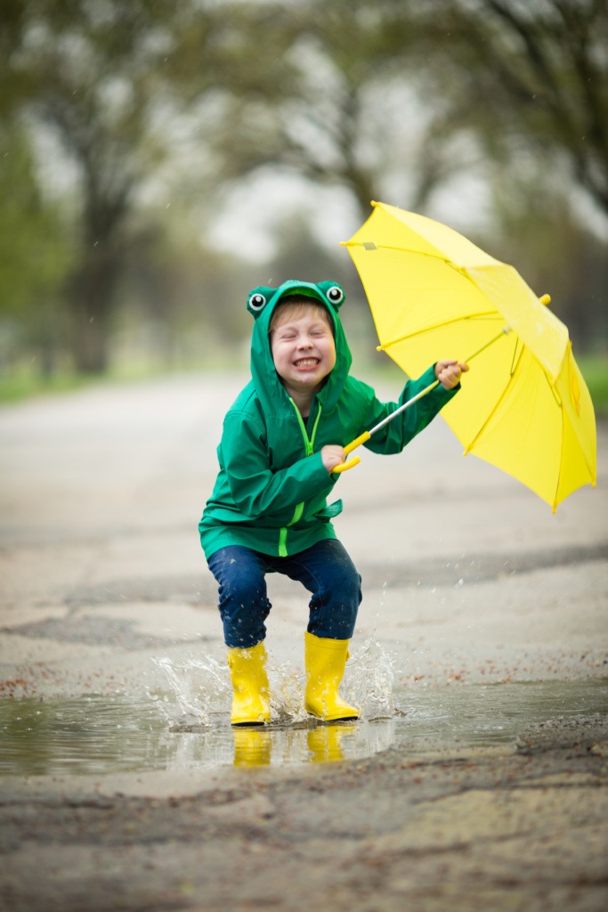 Young Boy Jumping in Rain near Grand Forks Greenway