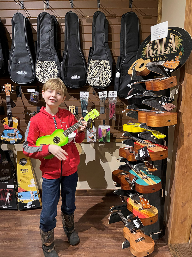 Jonas at Popplers Music in Grand Forks looking at guitars.
