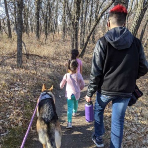 Courtney's children and dog walking along the Turtle River Park in Grand Forks