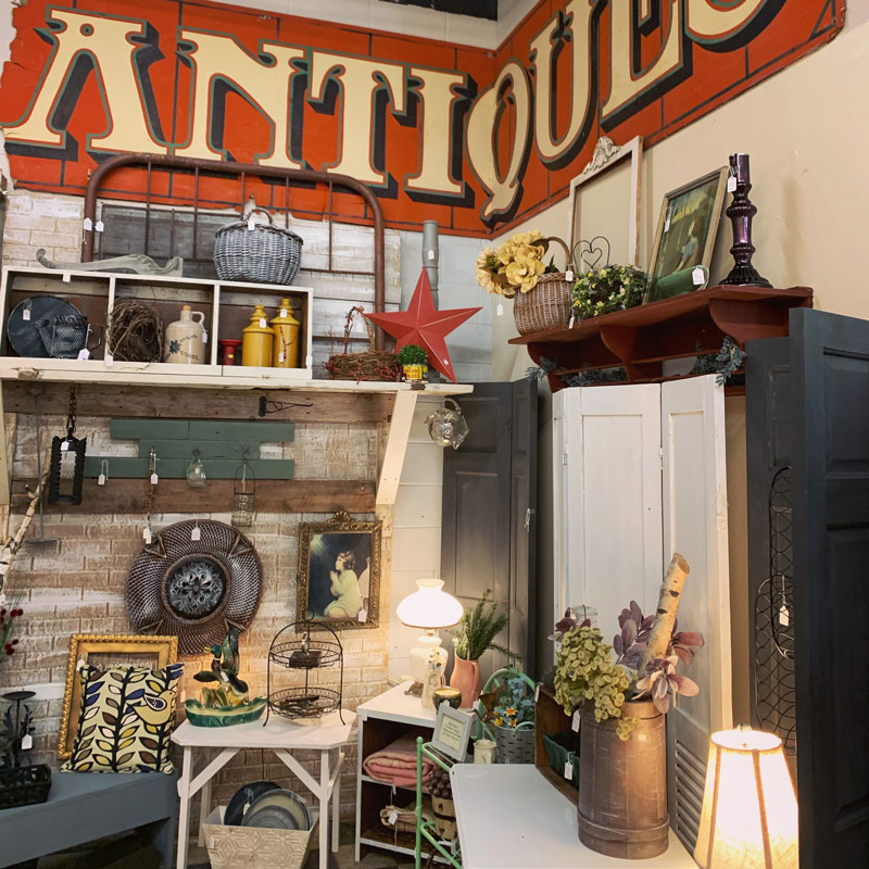 Grand Forks home decor Picks with a sign that says antiques on the wall