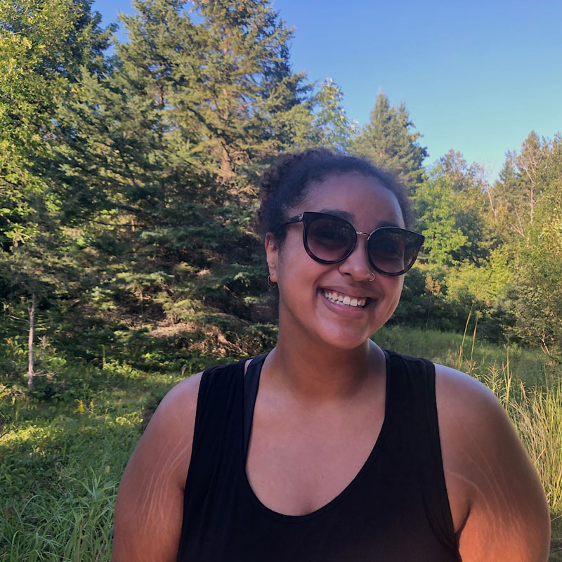Myra smiling while exploring Itasca State Park in Grand Forks