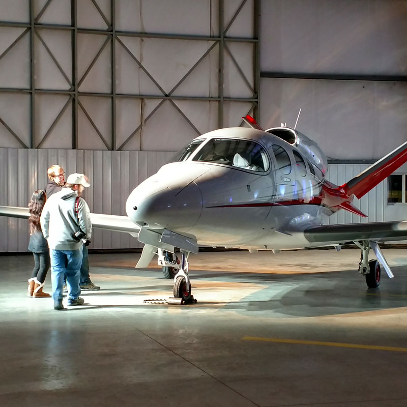 2 men and jet in a airplane hanger in Grand Forks in association with Cirrus Aircrafts