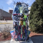 A Blue Head Planter wearing a mask as part of the public art in downtown Grand Forks