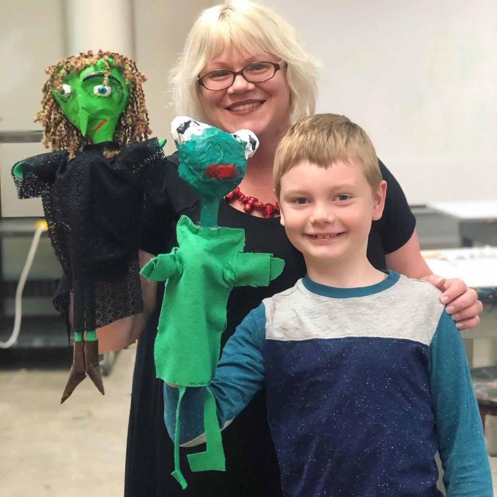 Jonas with a green felt puppet he made at Artwise in Grand Forks as one of his favorite spring time activities