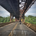 2 motorcycles on a bridge during the summertime in Grand Forks