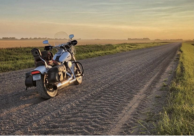 Motorcycle on a gravel road at sunset