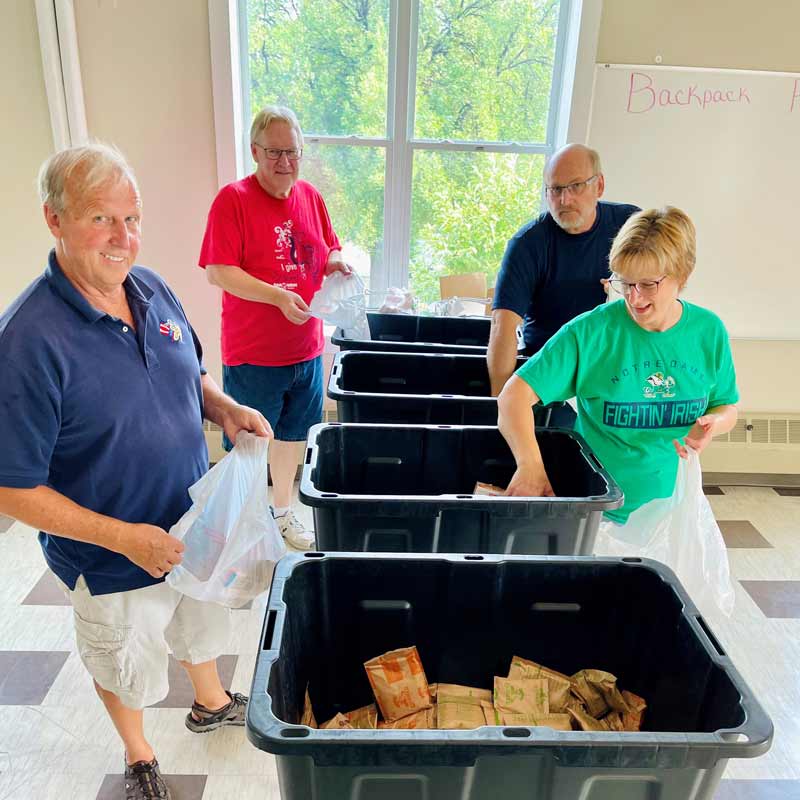 a group of volunteers packing bags in Grand Forks, North Dakota