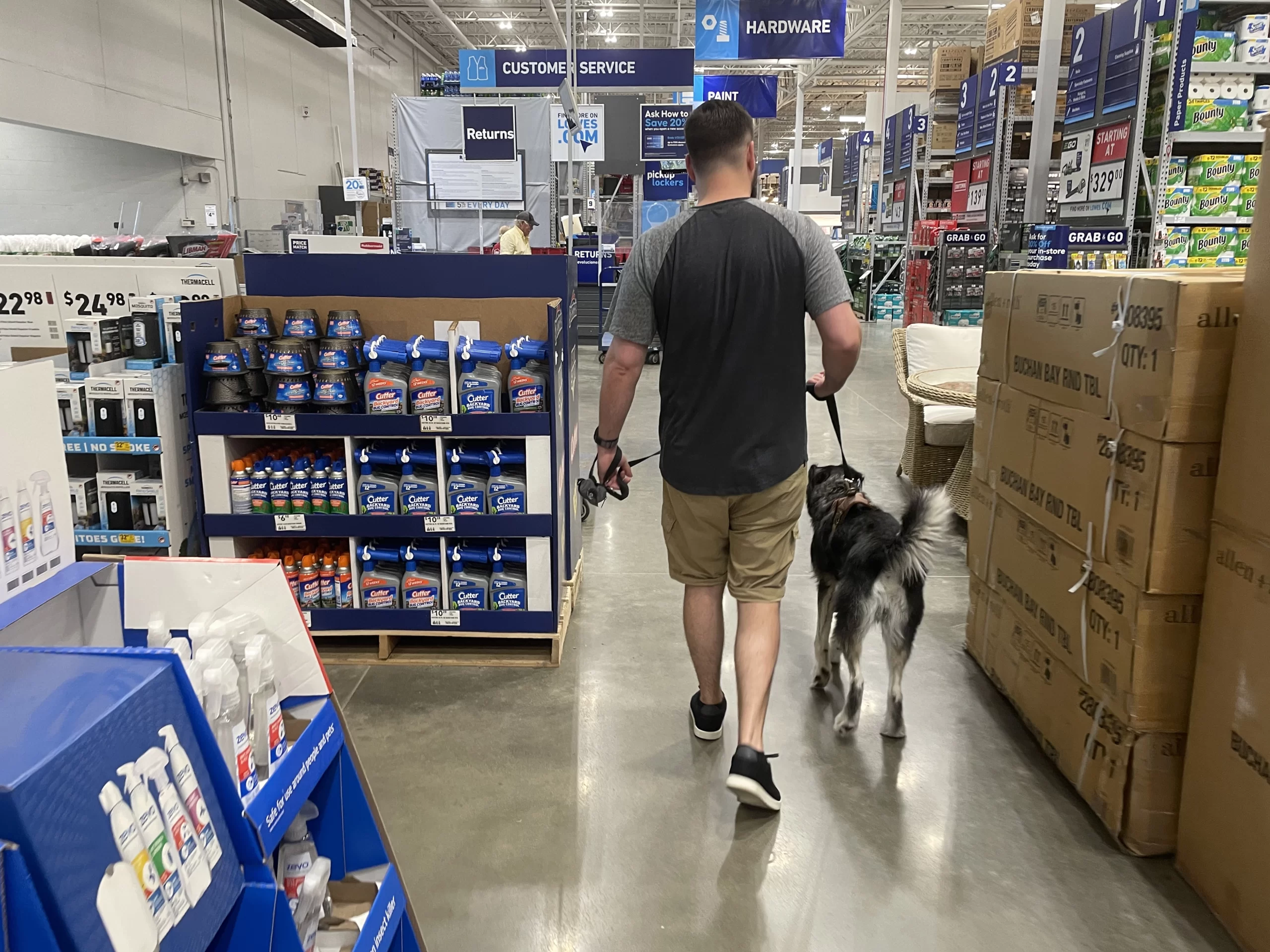 Man walking dog in Lowe's