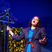 Woman singing on stage at Empire Theater Arts Center in Grand Forks, ND
