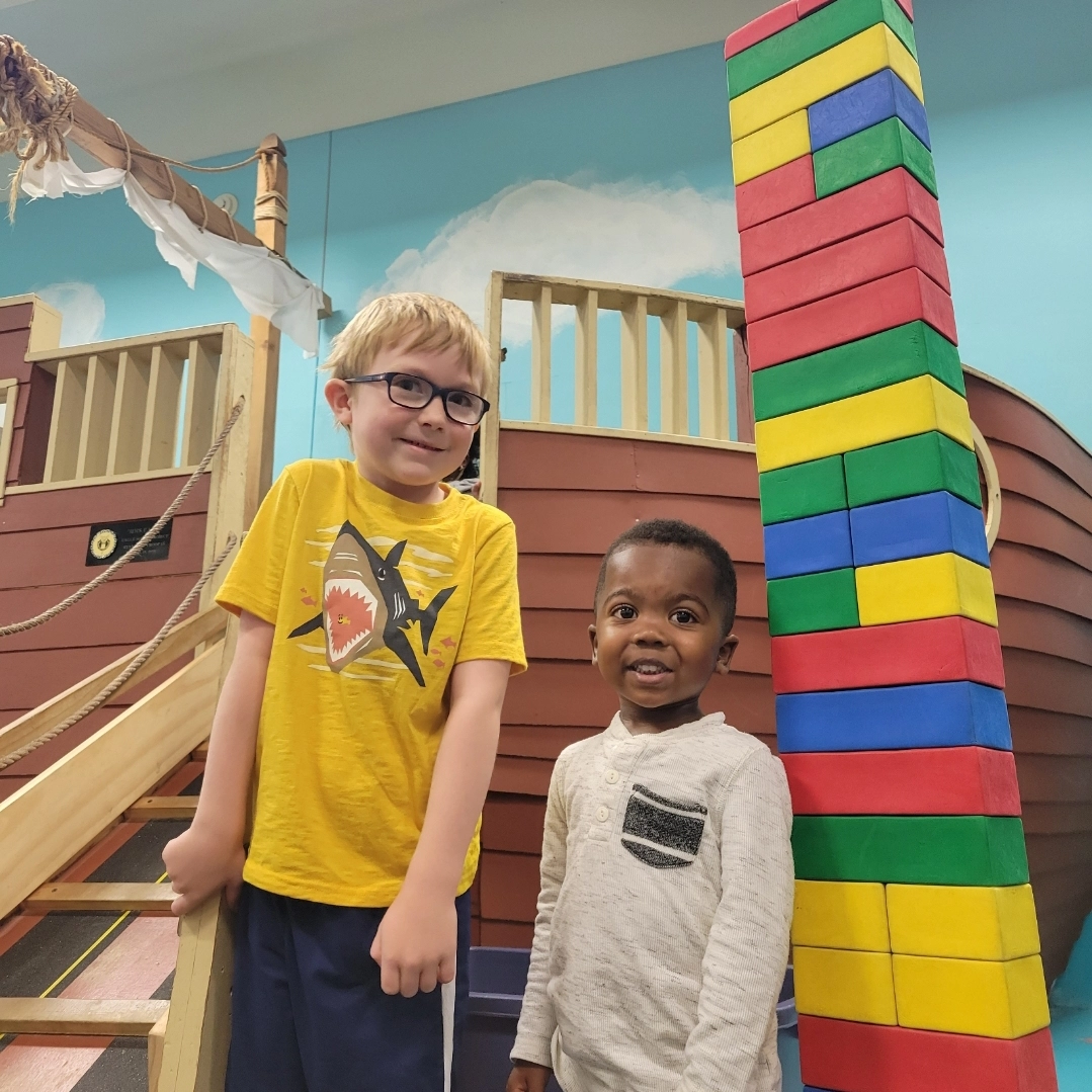 Two boys at the Grand Forks library with pirate ship and legos