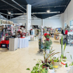 Shop with plants, clothing racks, and décor in Grand Forks, ND.