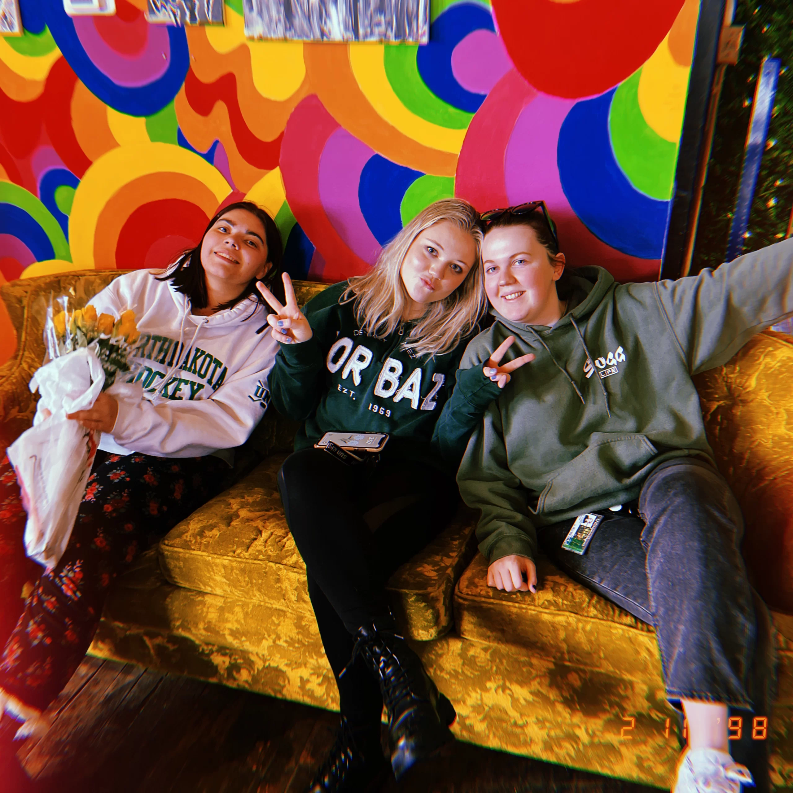 3 girls sitting on the couch at urban stampede in Grand Forks.