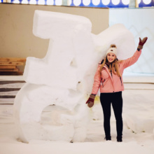 Posing-by-snow-sculpture-in-downtown-Grand-Forks,-ND