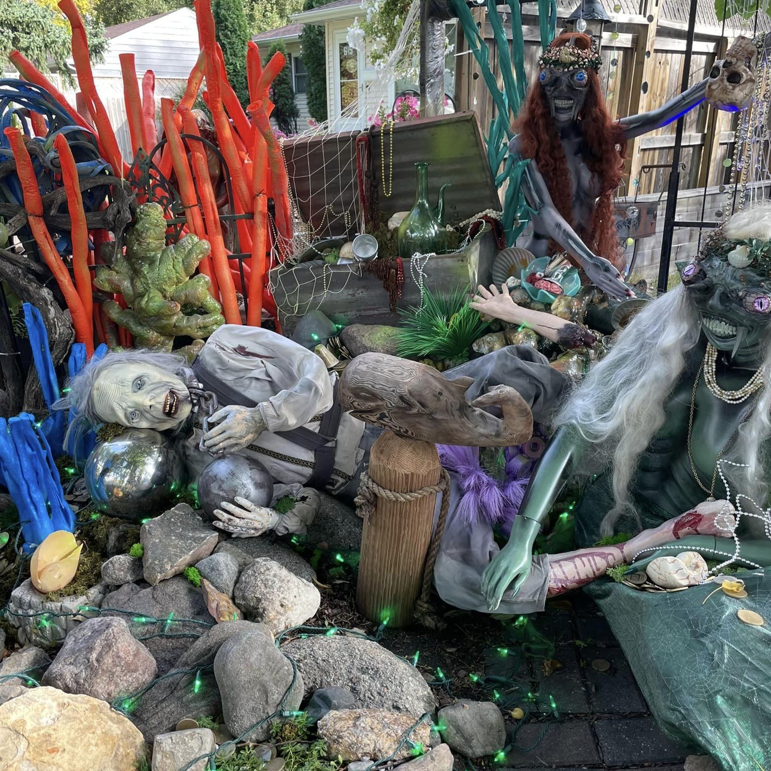 Halloween decorations depicting mermaids, their victim, a treasure chest, and a seascape.