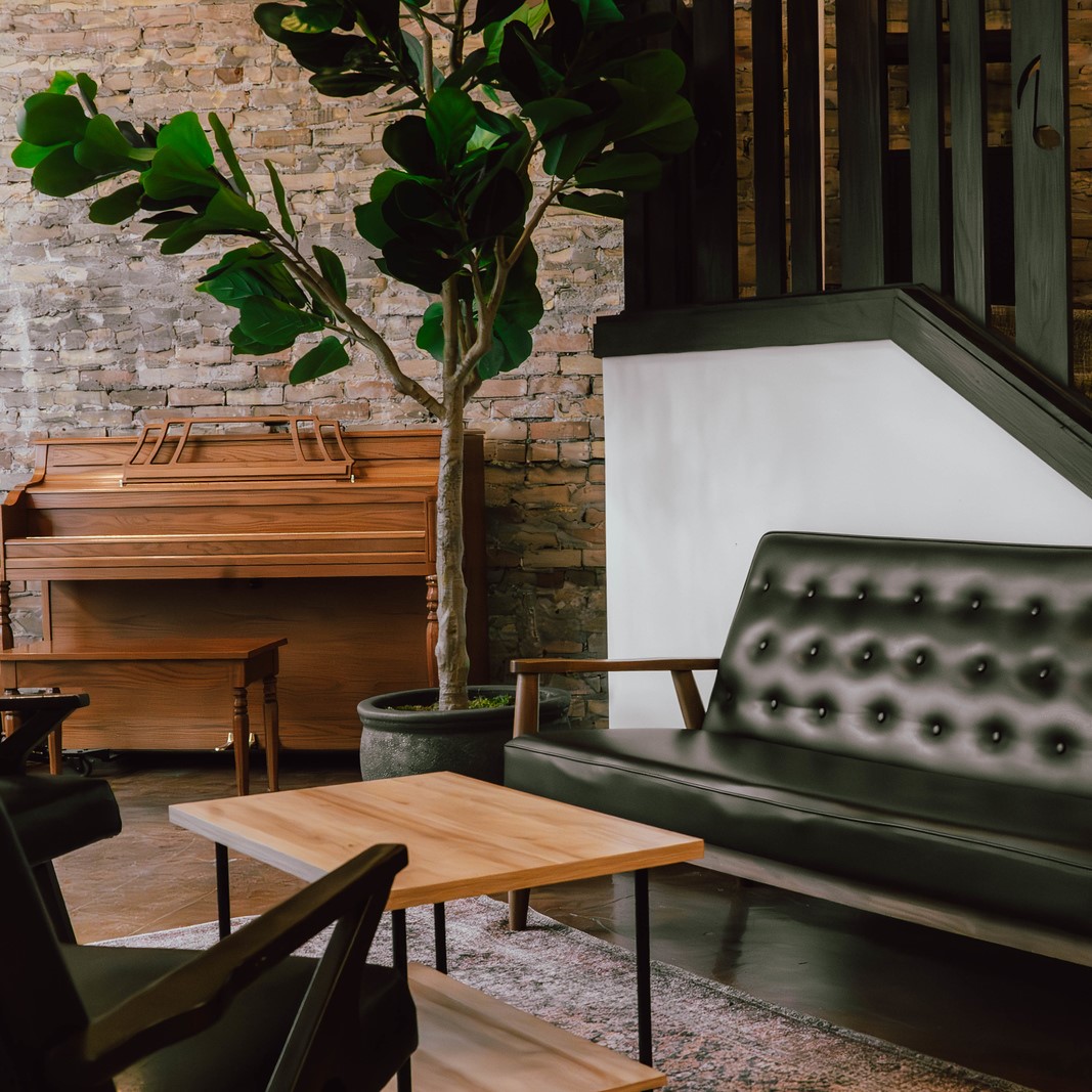 A coffee table, leather futon, and piano warm up the Ember's front lobby.