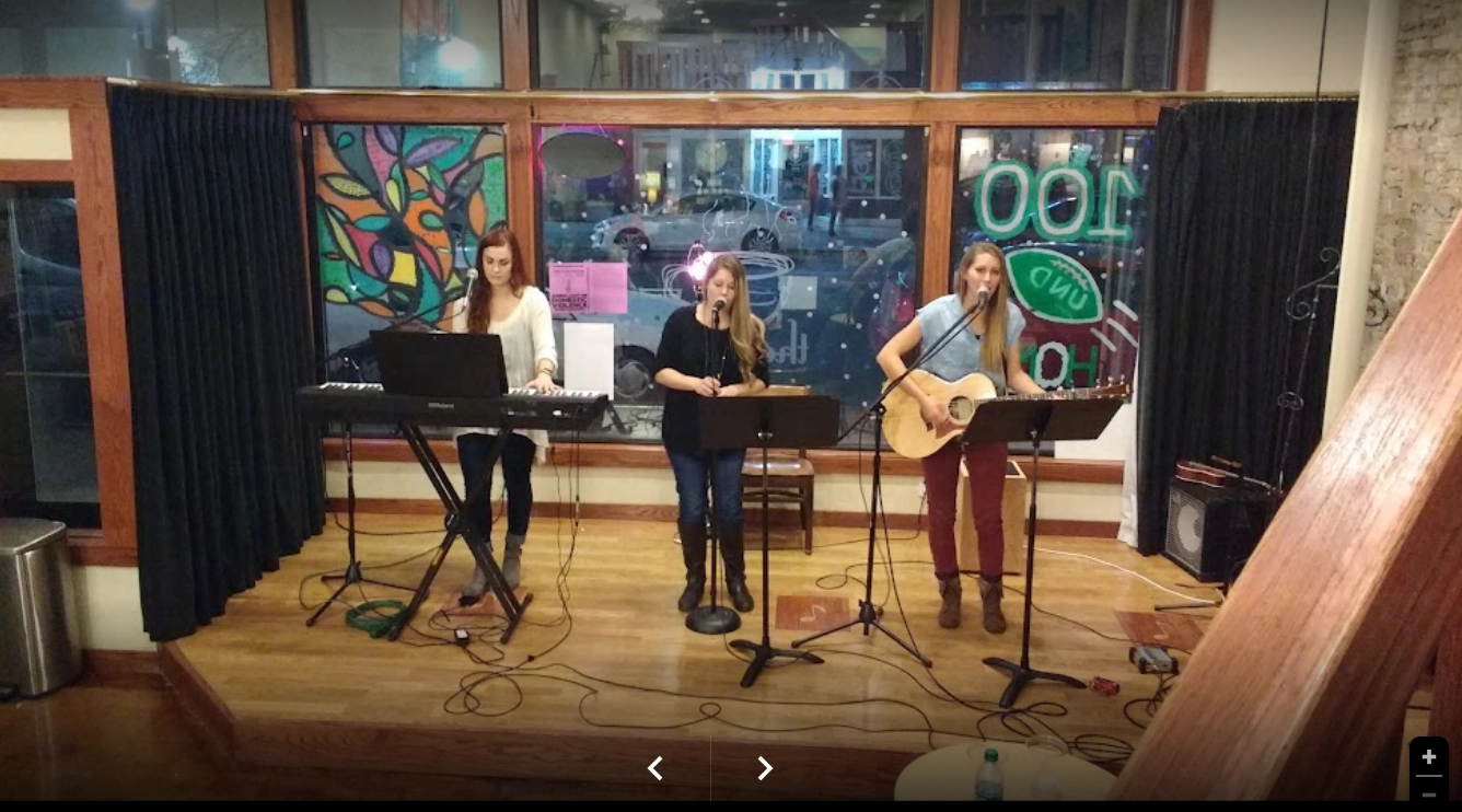 3 woman singing on stage at the Ember Coffeehouse in Grand Forks.