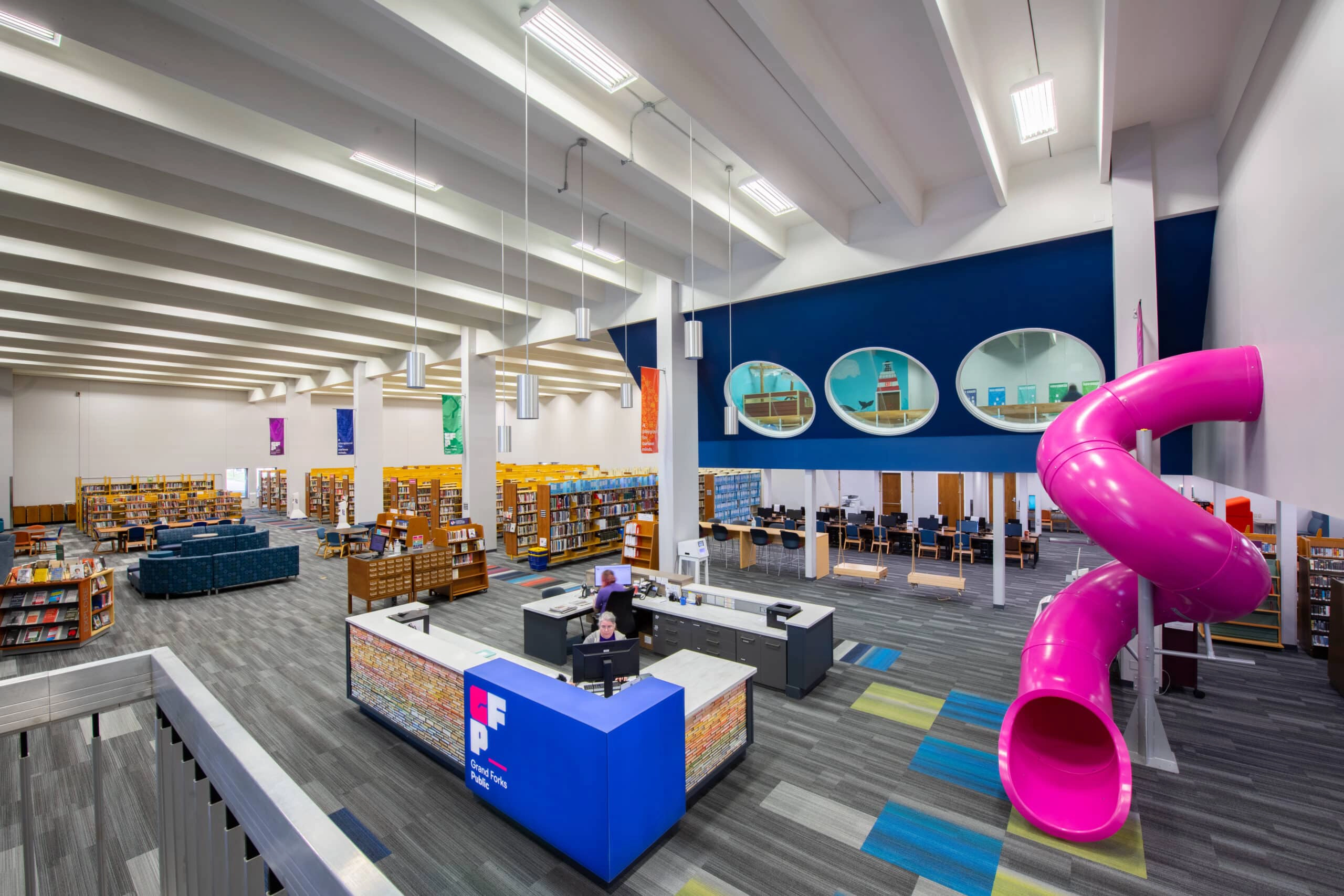 Grand Forks Public library with books and a pink slide.