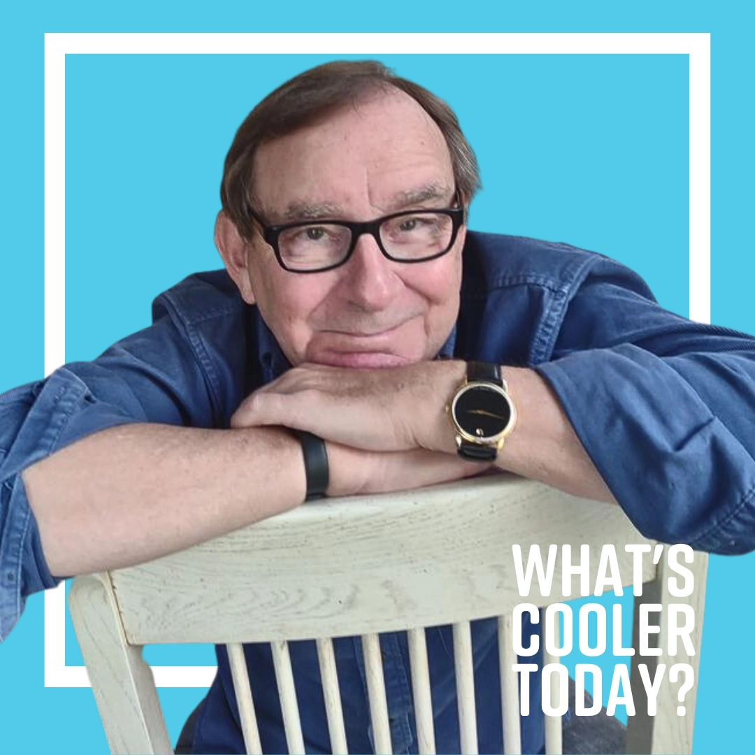 'WCT?' Grand Forks author Terry sitting on a chair in front of blue background.