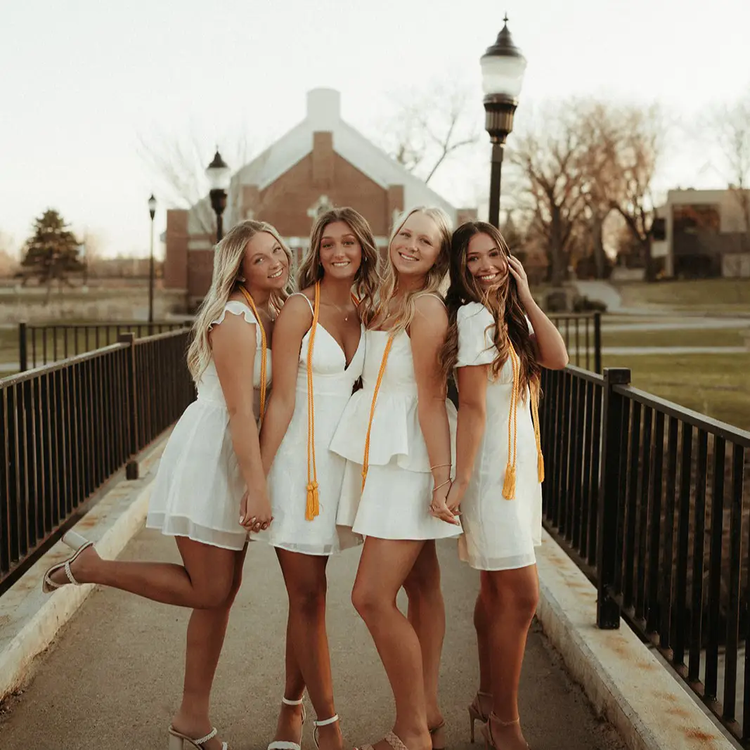 Girls pose on the bridge on UND Campus in Grand Forks