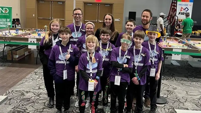 Grand Forks robotics team poses for victory picture at the Robotics Competition.