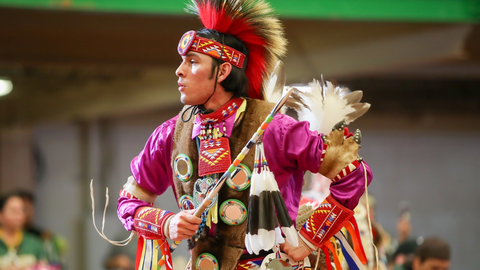 Man dressed in cultural attire dancing at Wacipi Powow in Grand Forks.