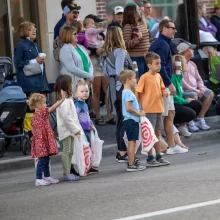 Kids standing waiting for candy at the Potato Bowl parade in Grand Forks.