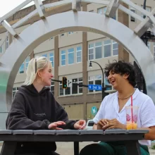 Jay and friend sit in Town Square in Summer in Grand Forks.