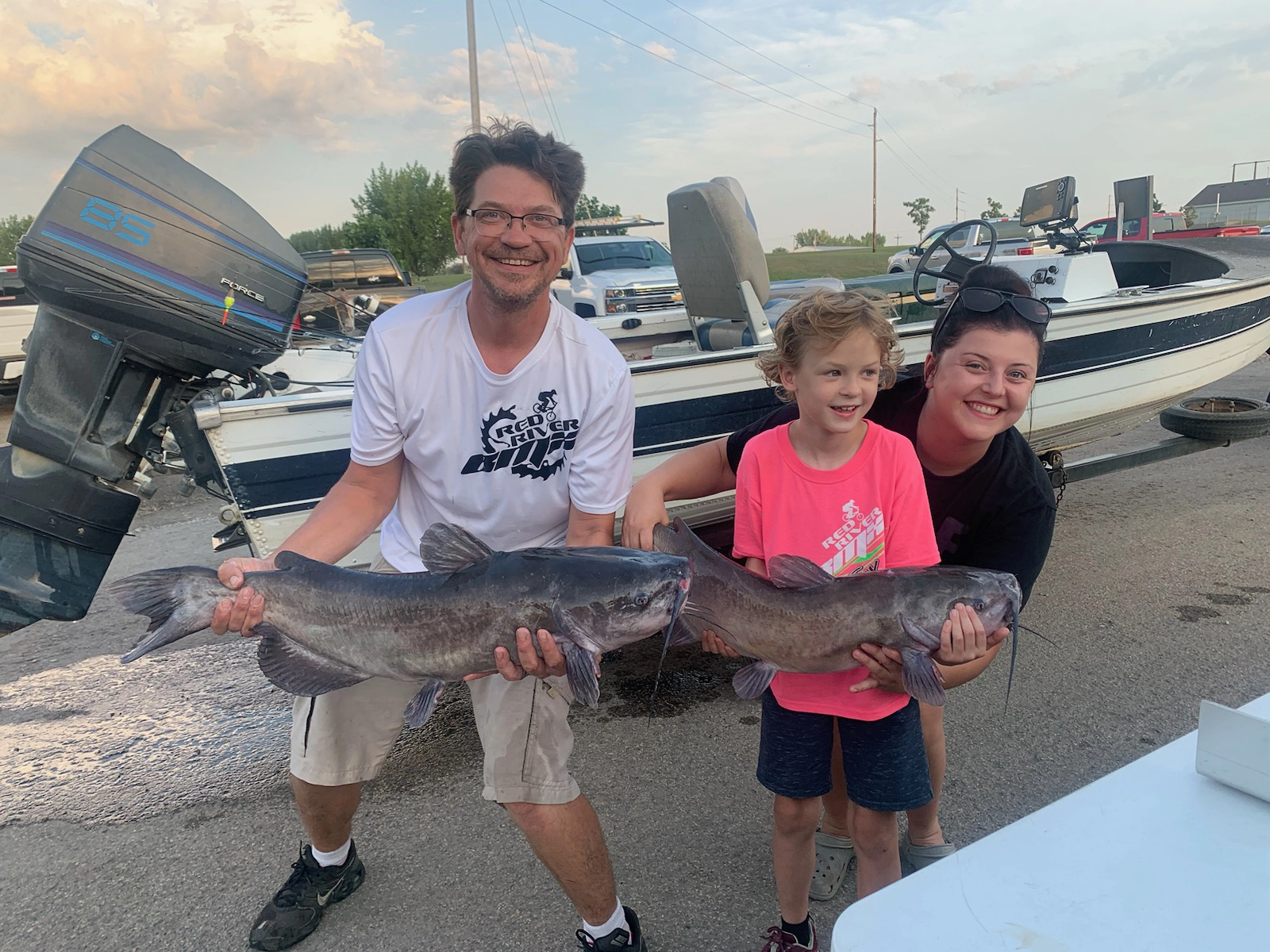 (left to right) Wade Anderson, Avery Anderson, and a volunteer from the Red River Valley Catfish League; July, 2023 on the Red River. Fish species: Channel Catfish.