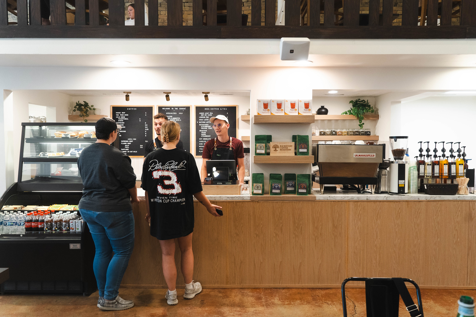 The counter at the Ember, where two young people place their order with the two employees on the other side of the counter.