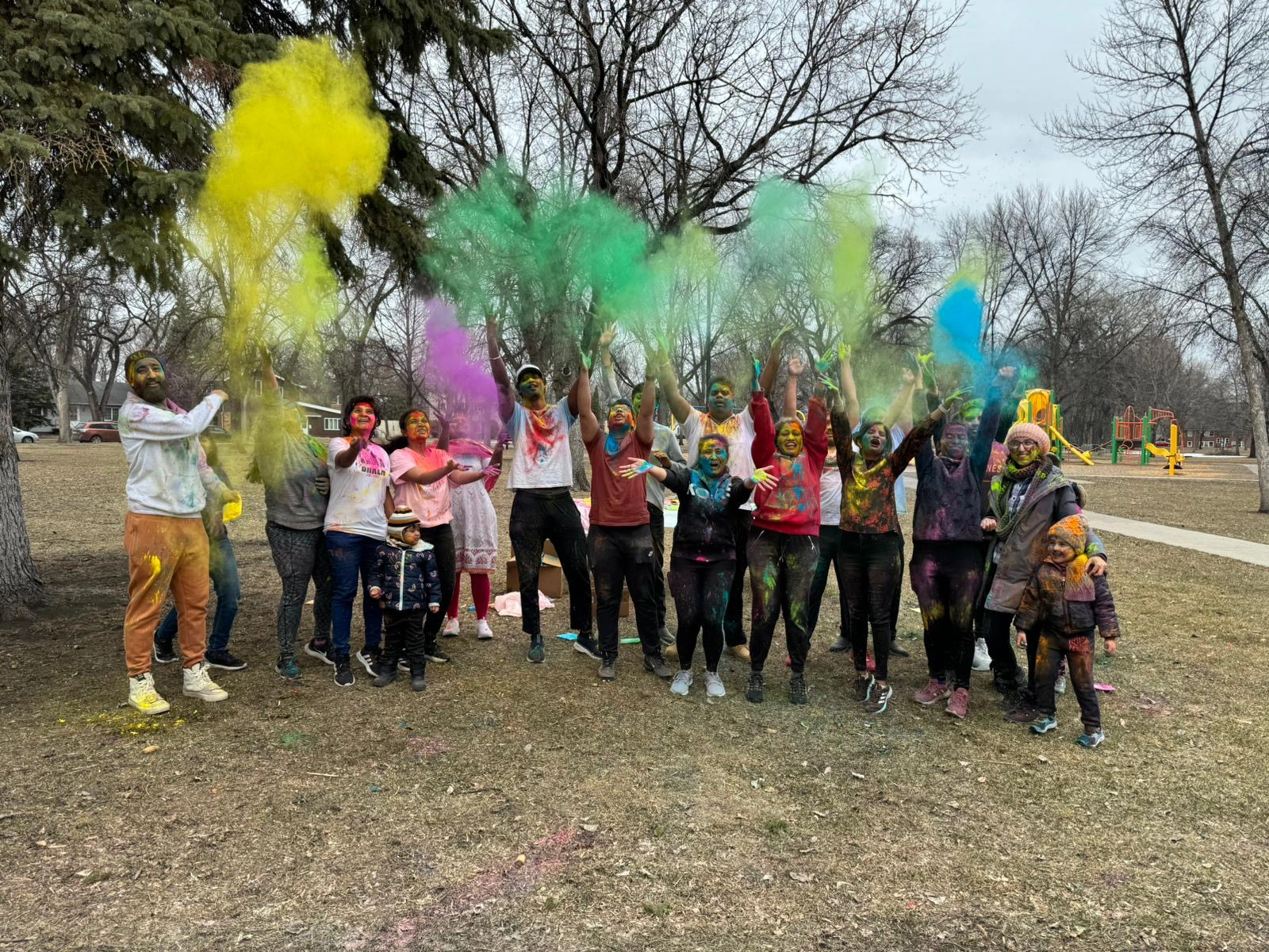 International Students in Grand Forks throwing colored dust into the air.