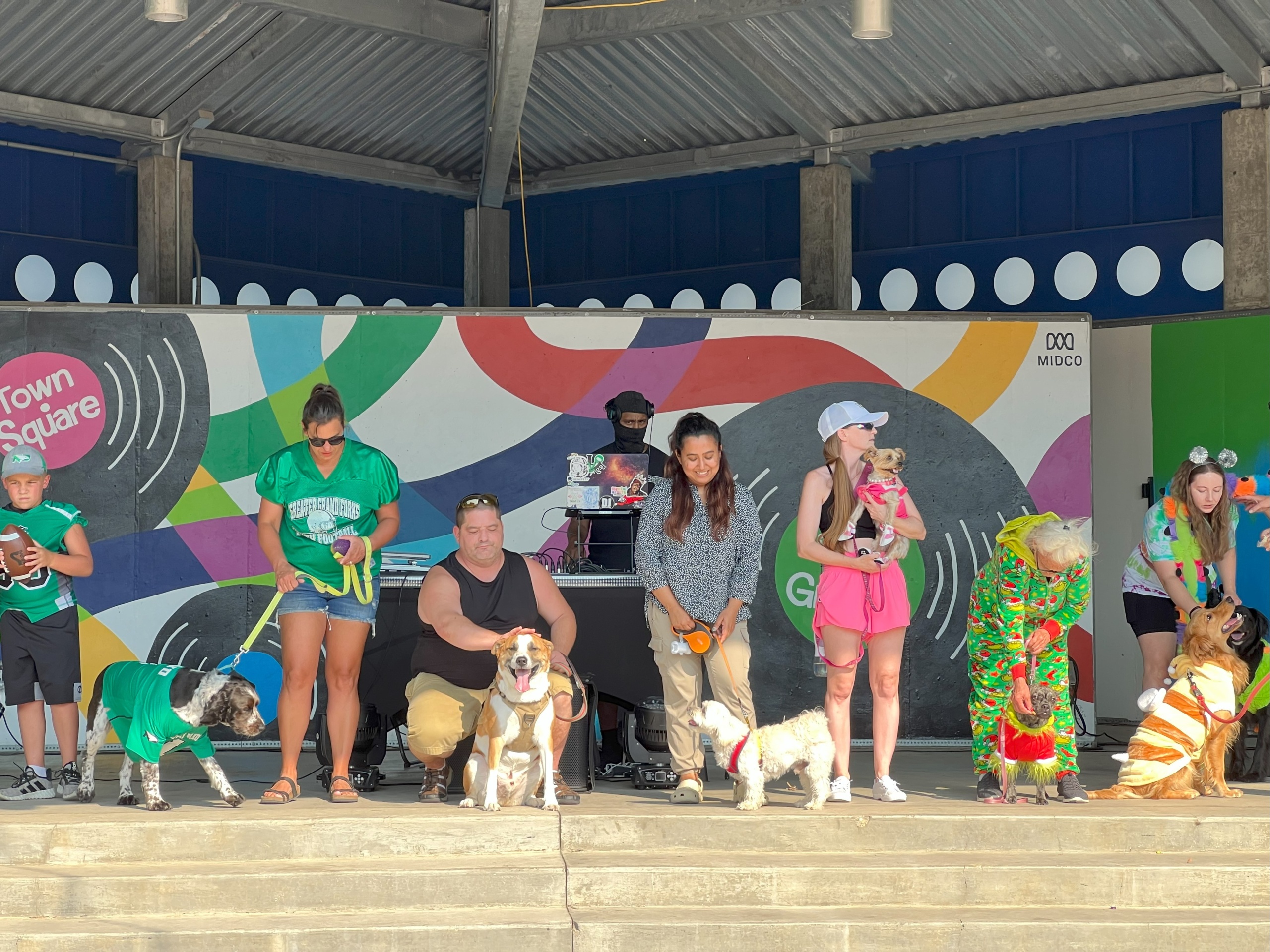 WCT writer Benu stands with her dog, Rio, in a line of other proud owners and their pups during the Puppy Parade at the Downtown Street Fair