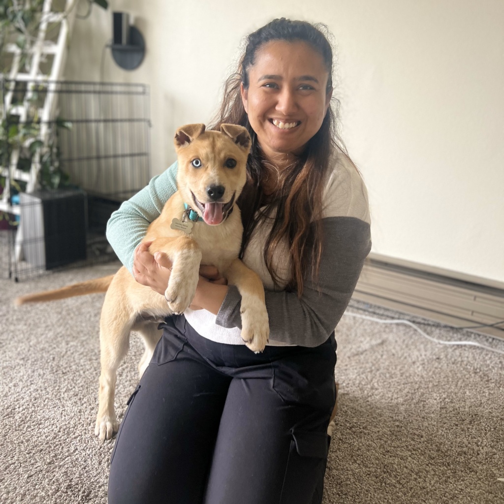 WCT Author Benu holds a tan puppy with heterochromia