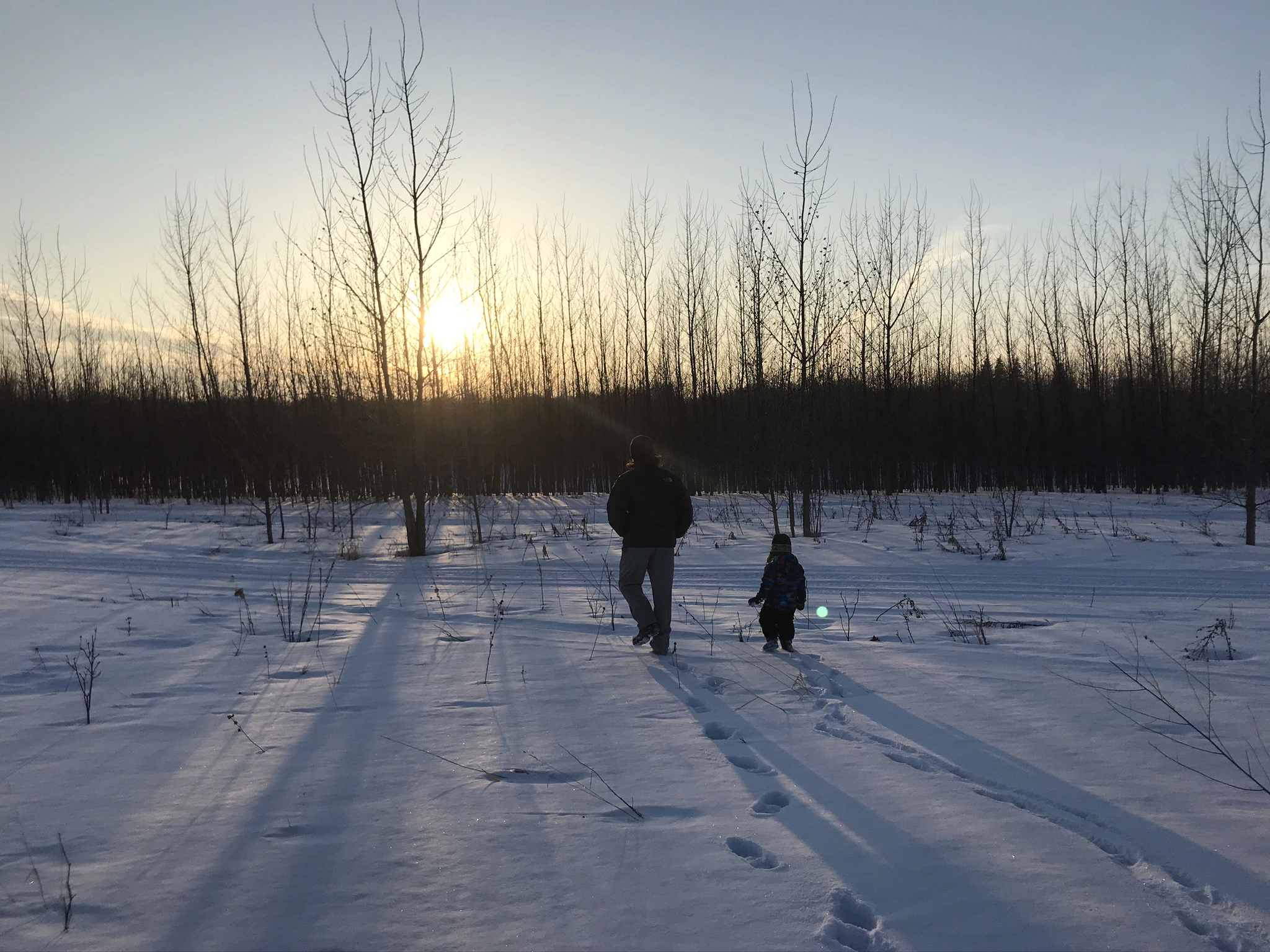 Wade and Jude Anderson walking toward the river on a snowy day