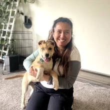 WCT Author Benu holds a tan puppy with heterochromia