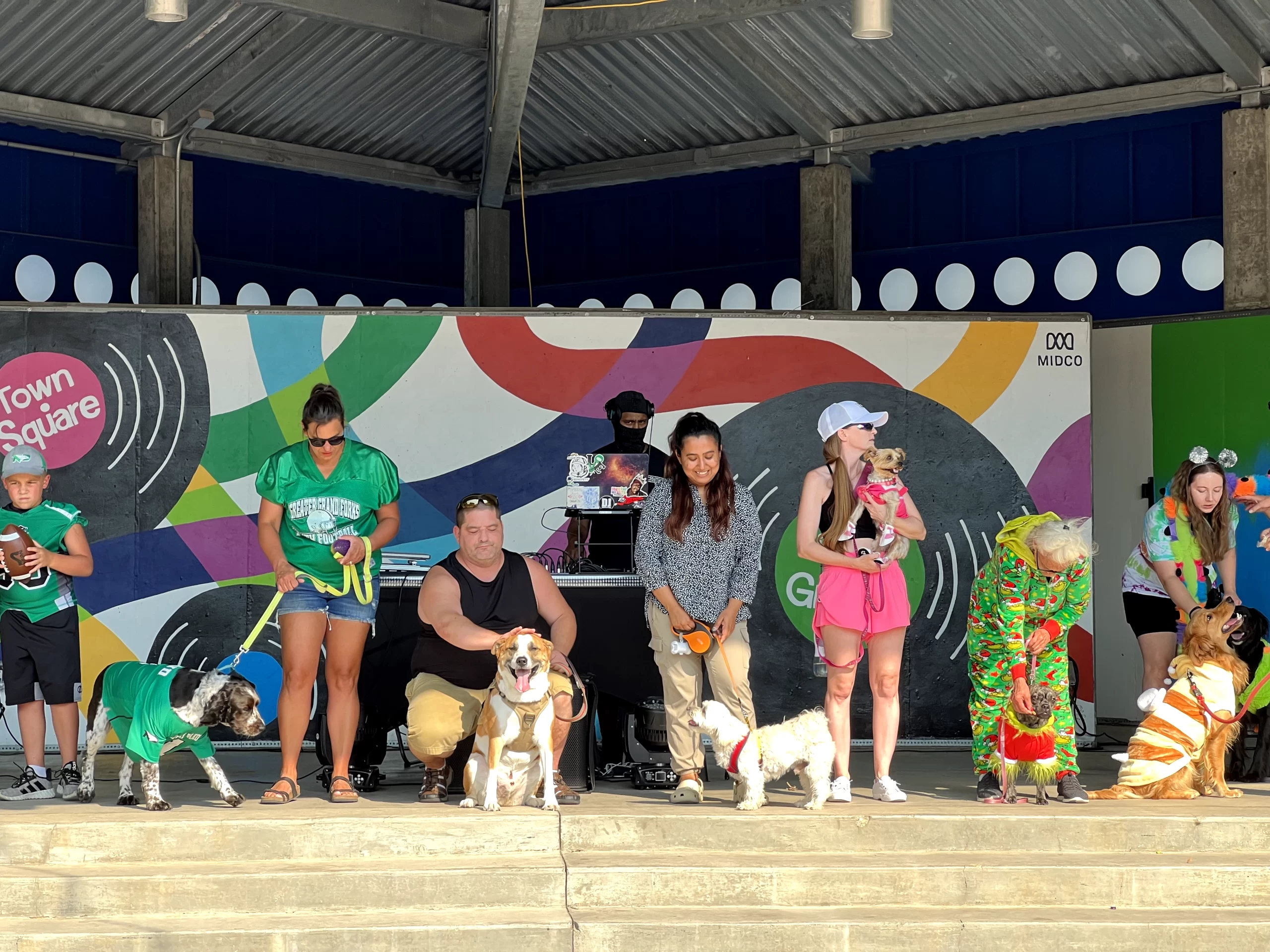 WCT writer Benu stands with her dog, Rio, in a line of other proud owners and their pups during the Puppy Parade at the Downtown Street Fair