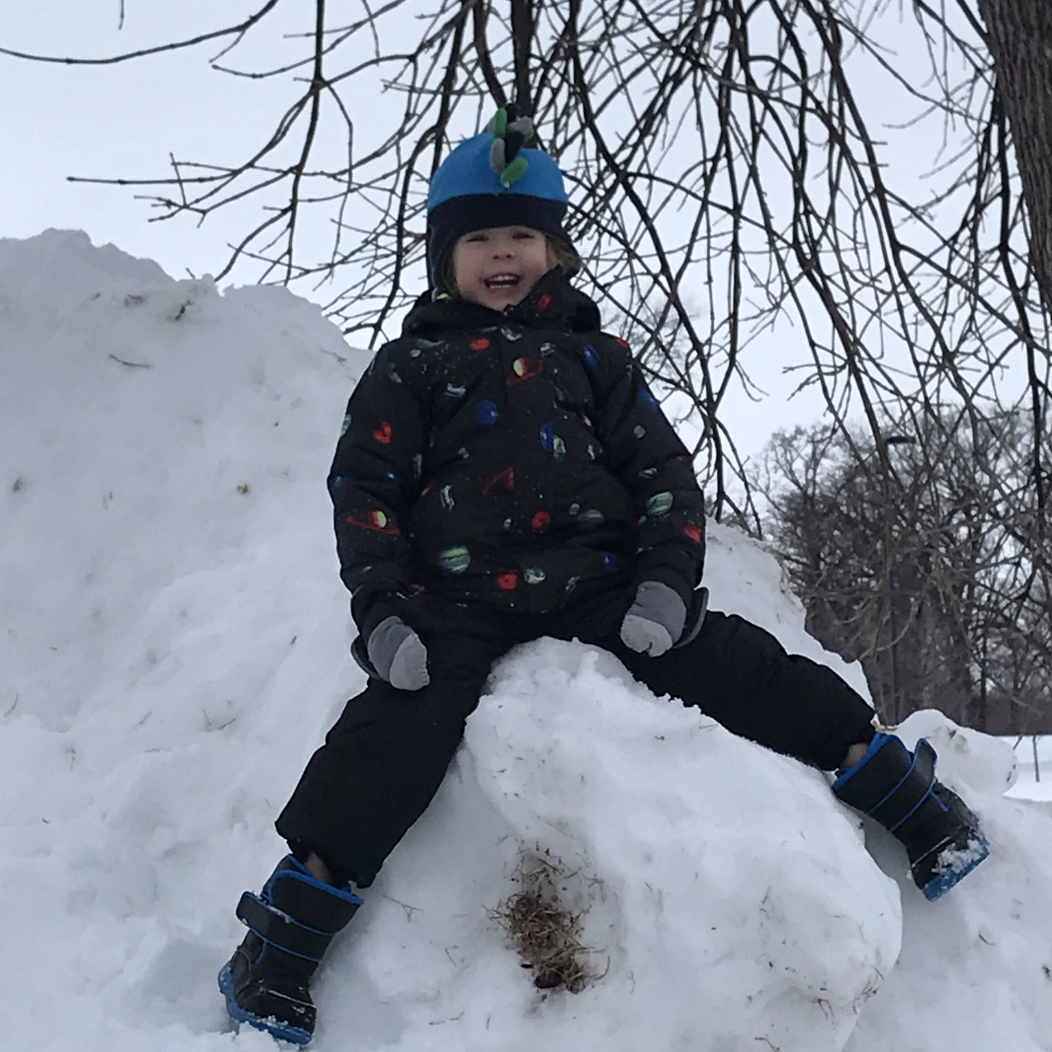 Avery Anderson playing on a snow hill