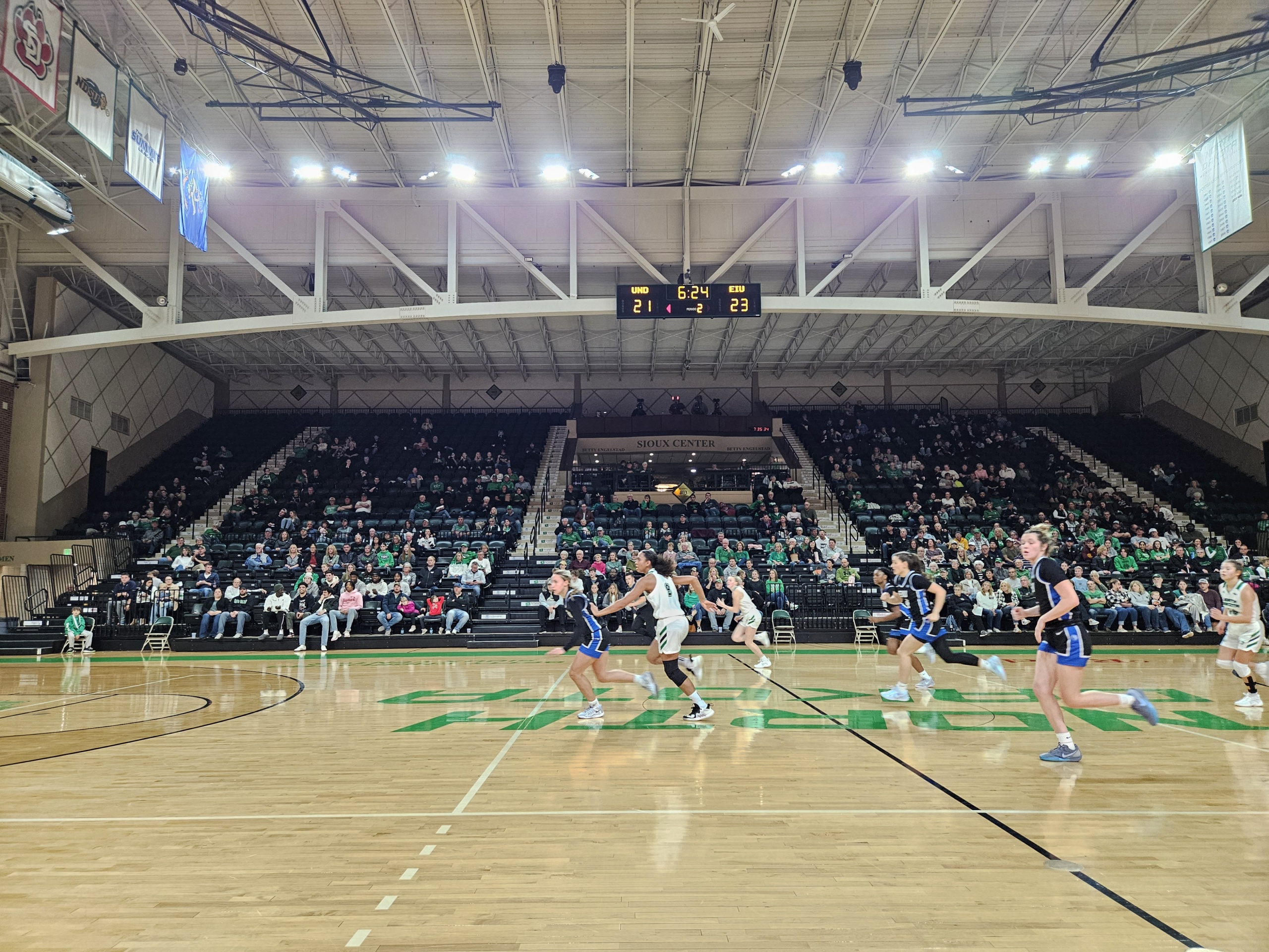 The UND women's basketball team rushes toward the basket mid-game at the Betty Arena.