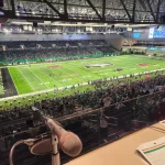 From te announcement stand, the UND football game at the Alerus Center plays on.