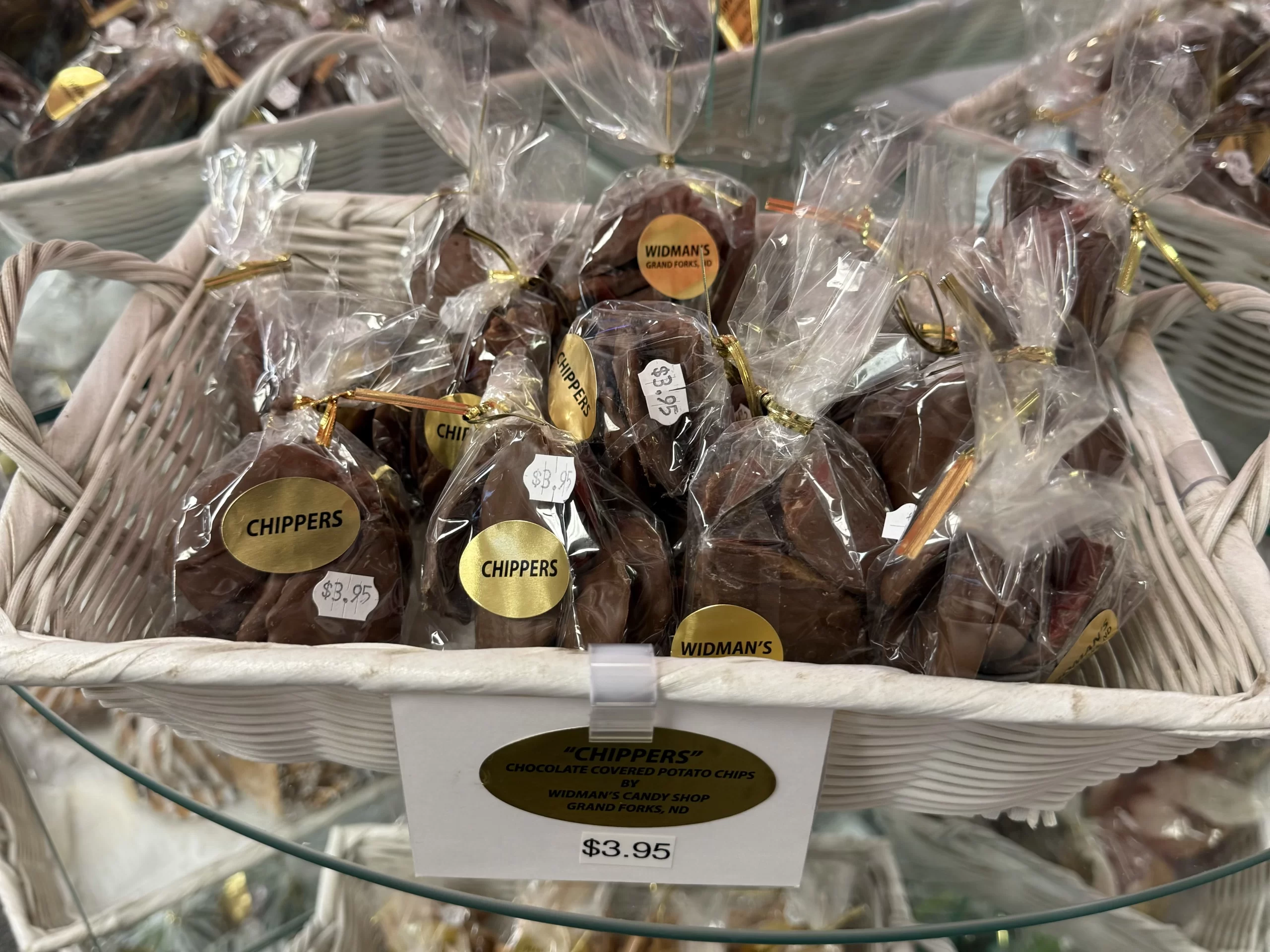 A basket full of individual sized portions of Chippers at Widmans, packaged in transparent bags and marked at $3.95.