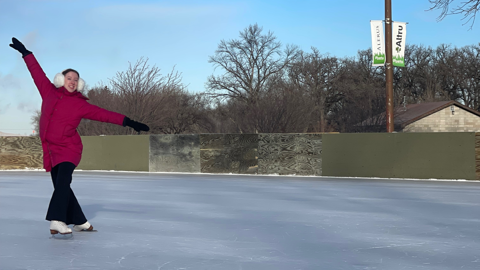 Skater Abby performs a bauer to show her moves to the camera. She is gliding in from the left hand side of the image. Smiling at the camera and posing nicely.