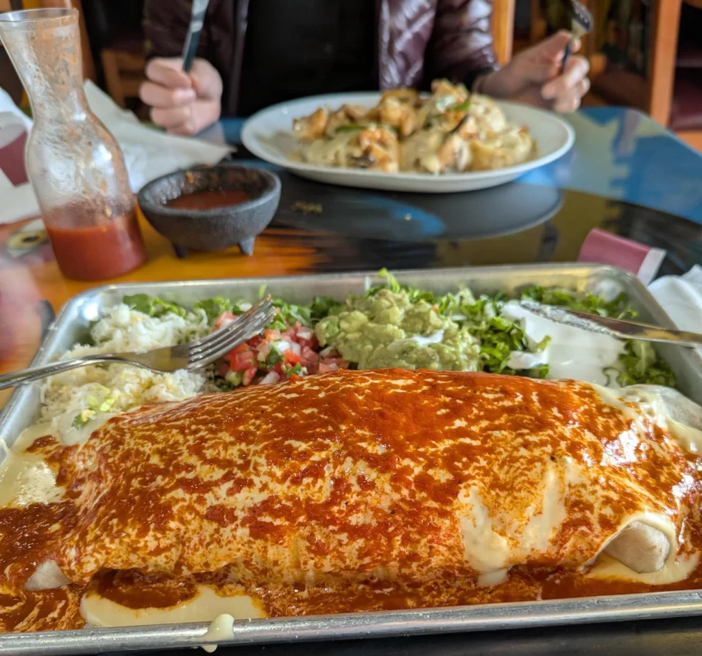 Author Adrian sits down to eat with his massive burrito at Chicago Burrito in Grand Forks