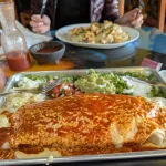 Author Adrian sits down to eat with his massive burrito at Chicago Burrito in Grand Forks